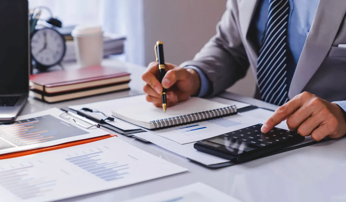 Business Financing, businessman doing finances and calculating about the cost to real estate investment and in other, tax system. Accounting Banking Concept