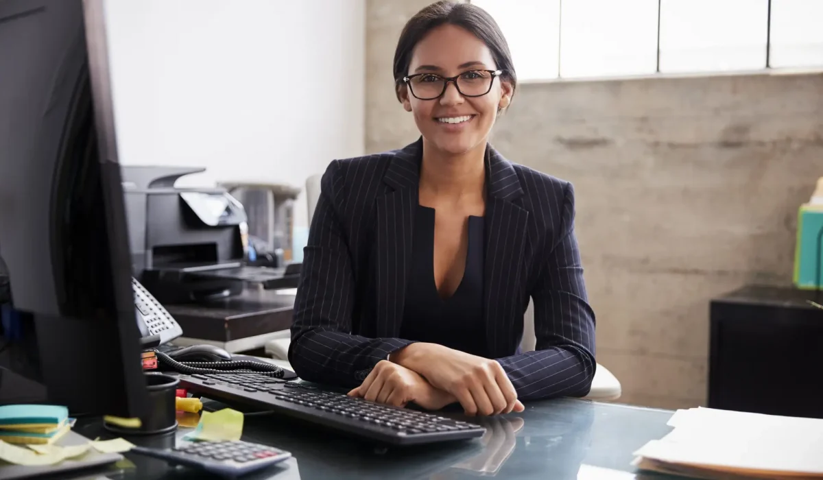 Young professional mixed race woman sitting in an office